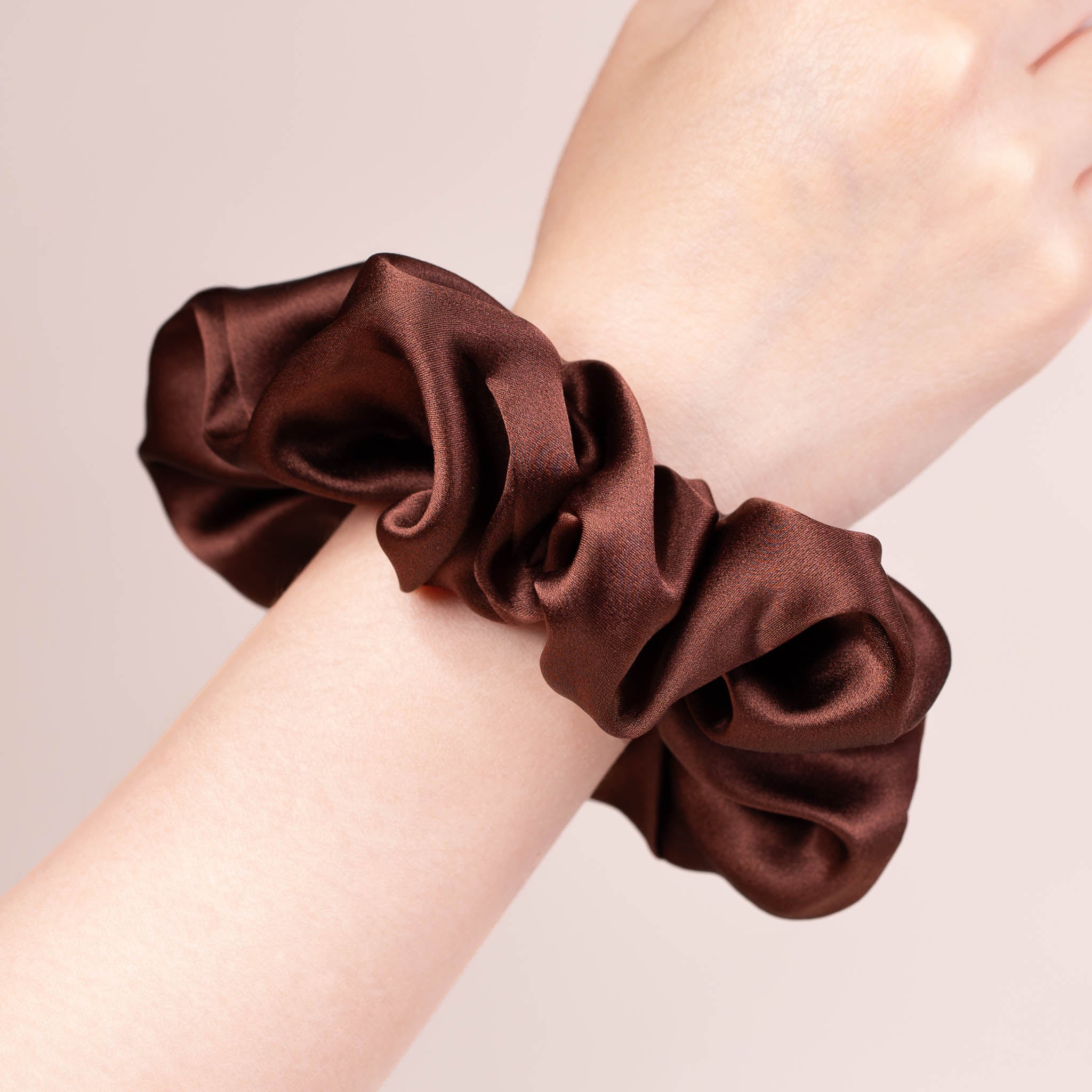 Large Silk Scrunchie in Dark Brown—a warm earthy deep brown —worn on a wrist, showing a natural soft sheen and gentle drape.