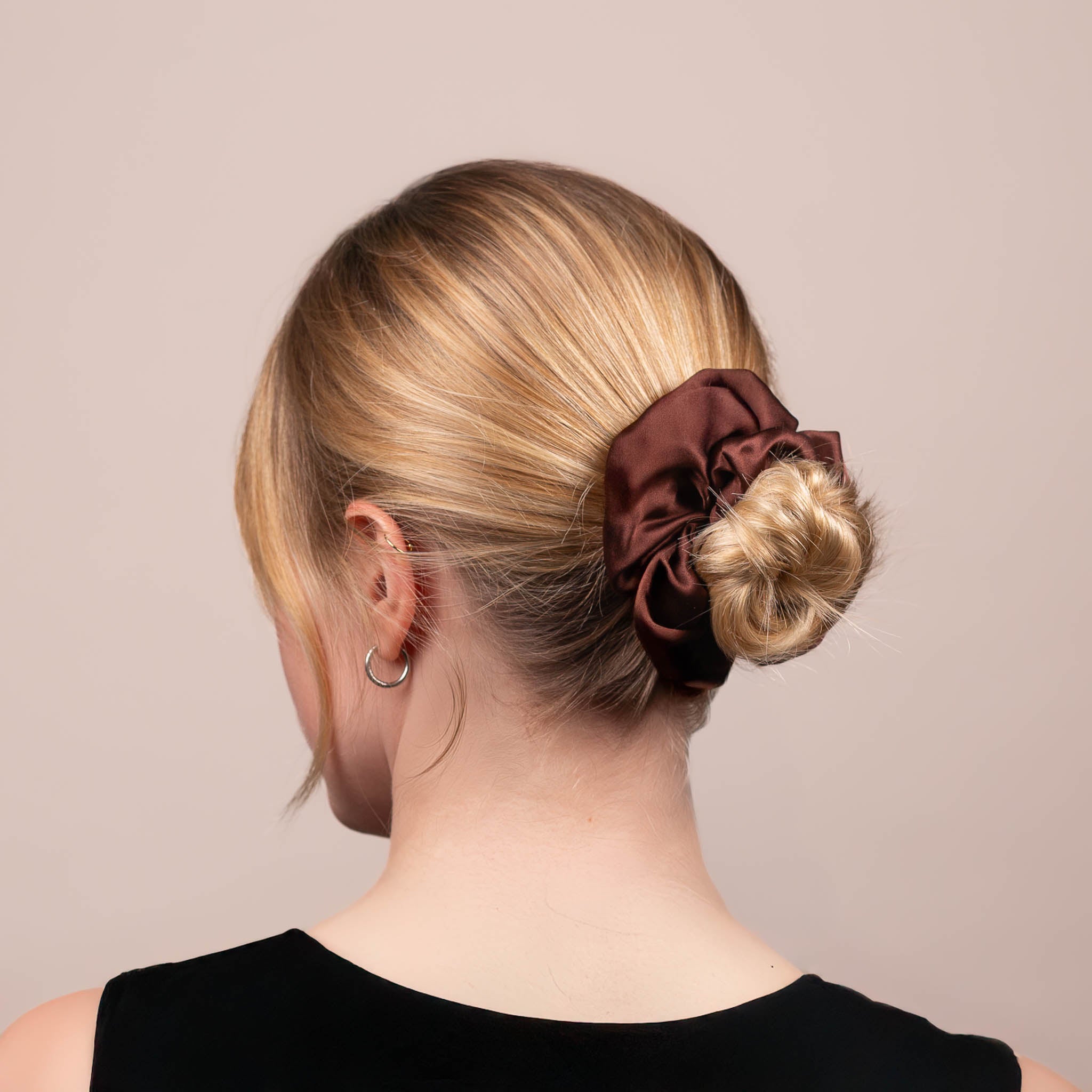 Side view of the Large Silk Scrunchie in Dark Brown securing hair in a low bun, showing its soft sheen and gentle drape.