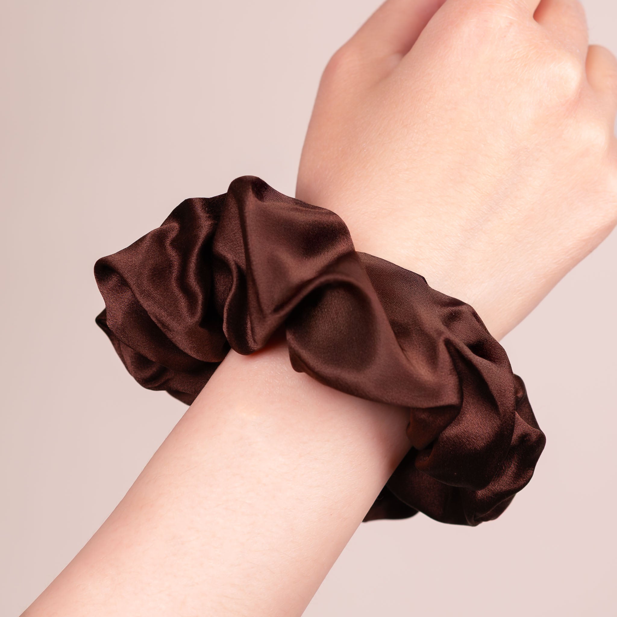 Large Silk Scrunchie in Dark Brown—a warm earthy deep brown —worn on a wrist, showing a natural soft sheen and gentle drape.