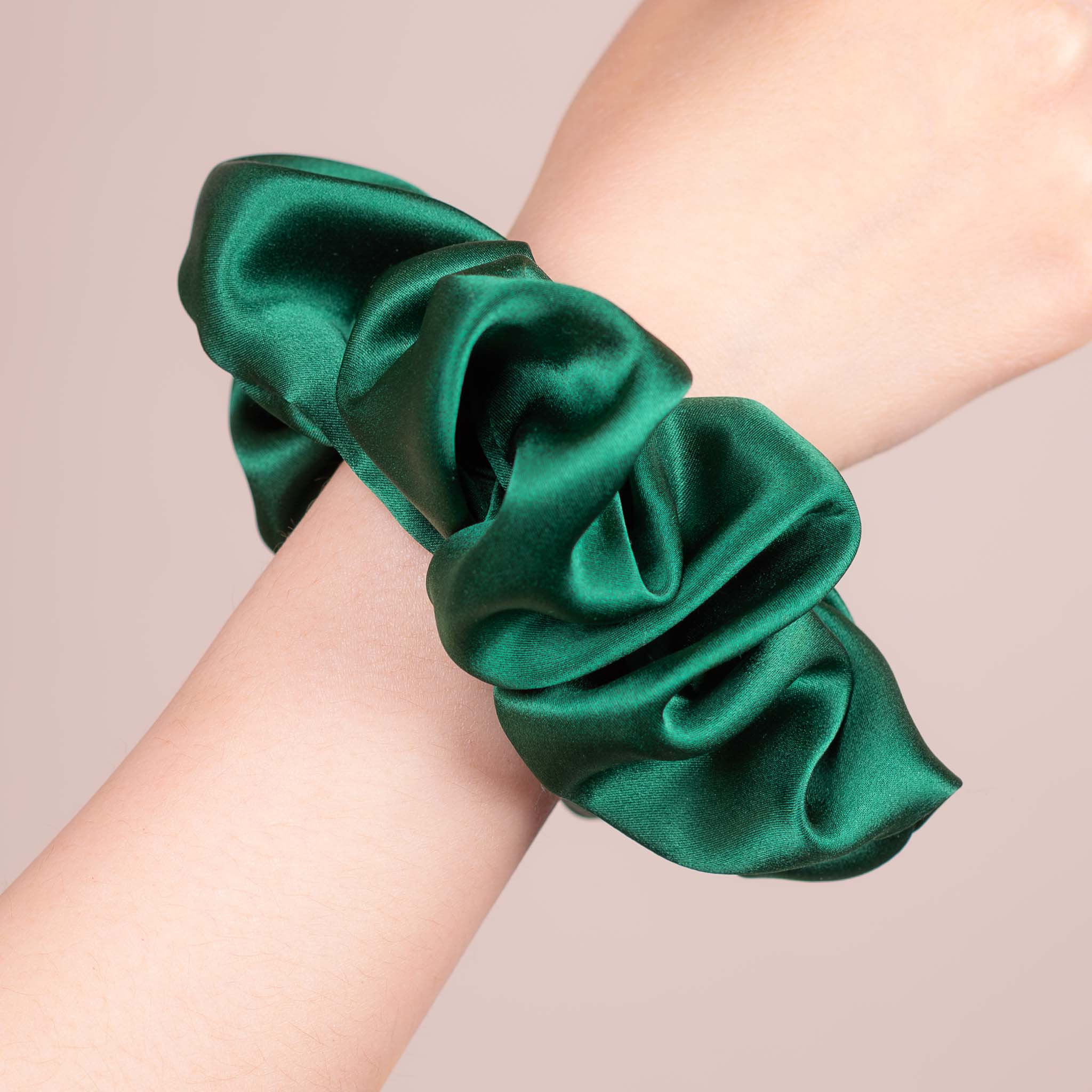 Large Silk Scrunchie in Emerald Green—a deep, rich teal—worn on a wrist, showing a natural soft sheen and gentle drape.