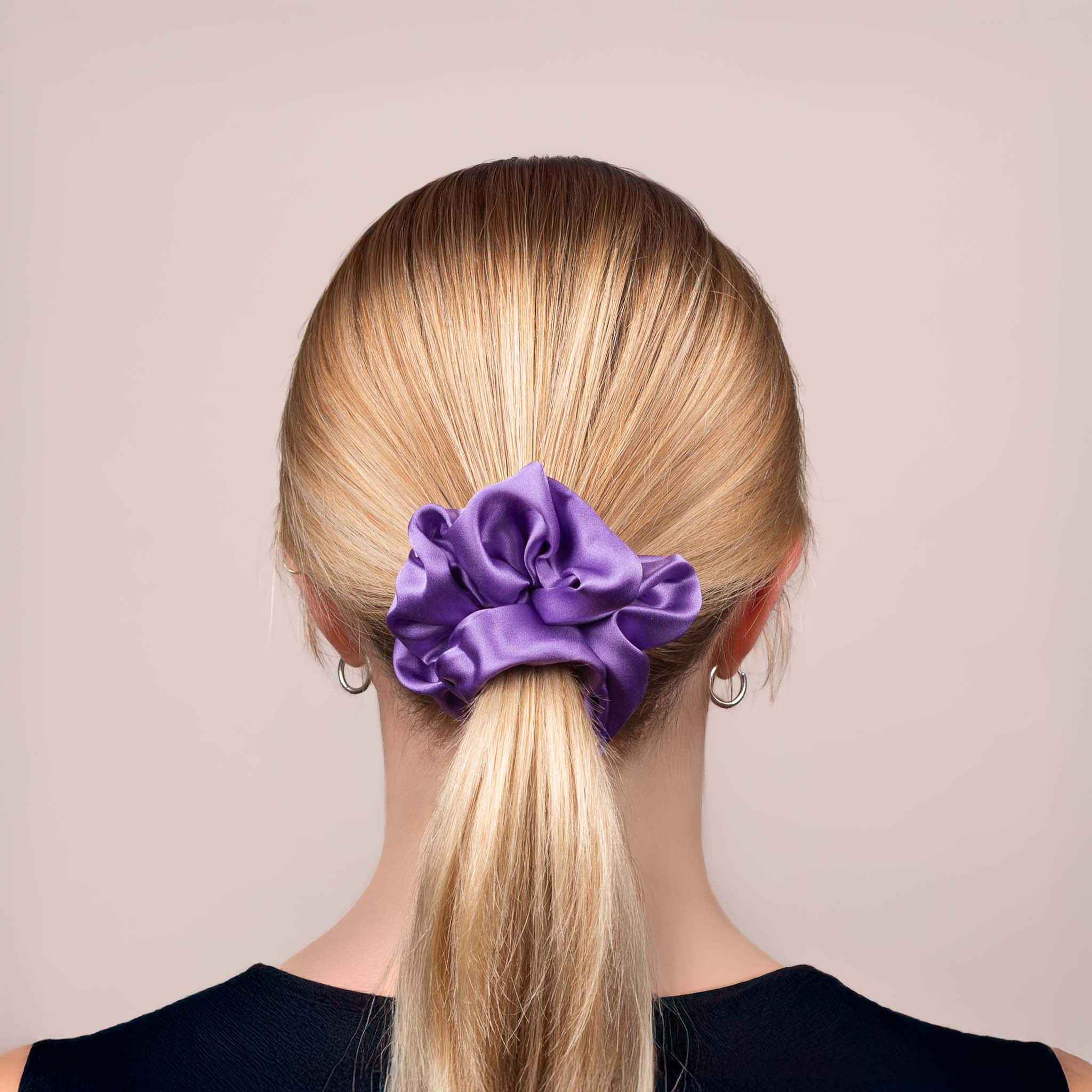 Back view of the Large Silk Scrunchie in Royal Purple, securing hair in a low ponytail, with a soft sheen and drape.